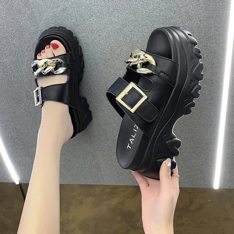 A pair of white, sponge cake-inspired sandals with a metal buckle, showcasing a unique and stylish Kiwi-inspired design.