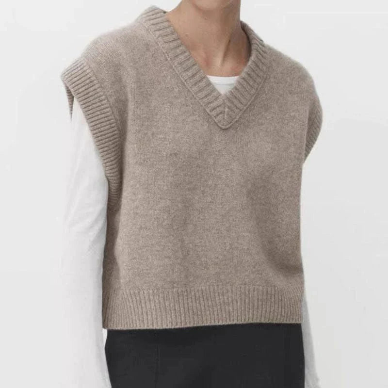 A cosy and stylish women's knitted vest in a neutral colour, with a V-neck design and sleeveless silhouette for easy layering.