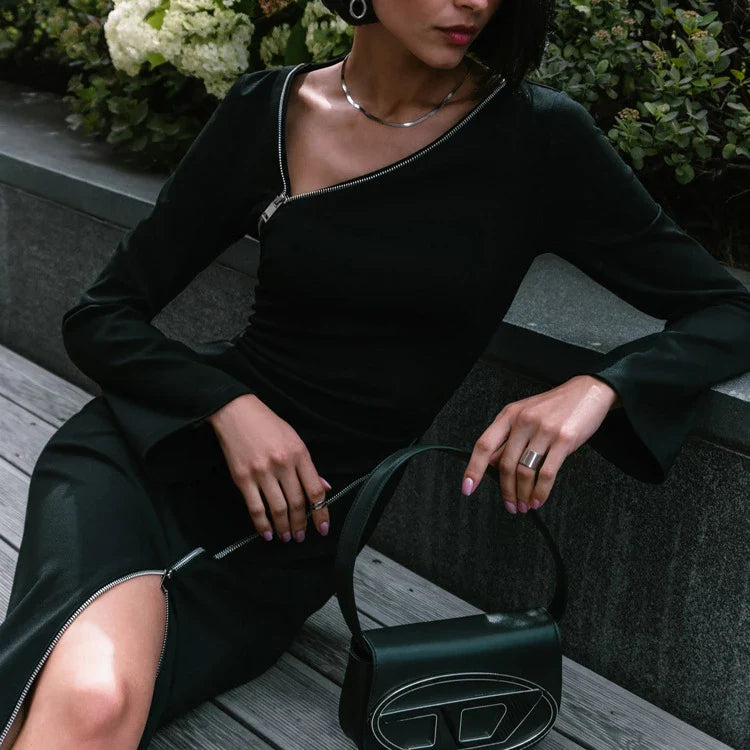 Stylish black crossbody bag with sleek zipper details and long skirt silhouette