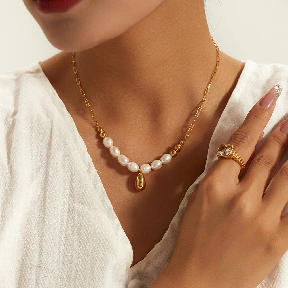 Elegant pearl and gold pendant necklace with a delicate gold drop, a timeless accessory for New Zealanders