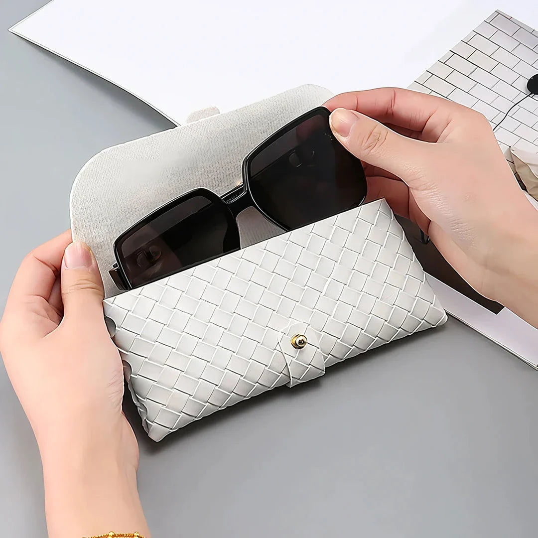 Stylish black and white twist braided leather sunglasses case with snap closure, protecting eyewear in a fashionable way