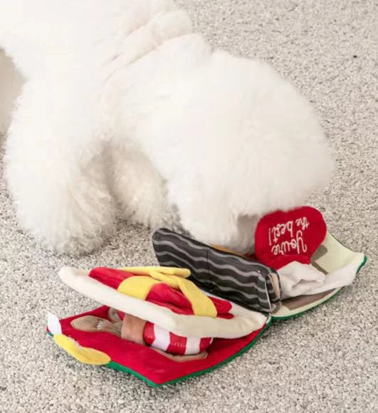 A festive red plush dog toy with a hide-and-seek design, perfect for Kiwi pups to play and discover treats