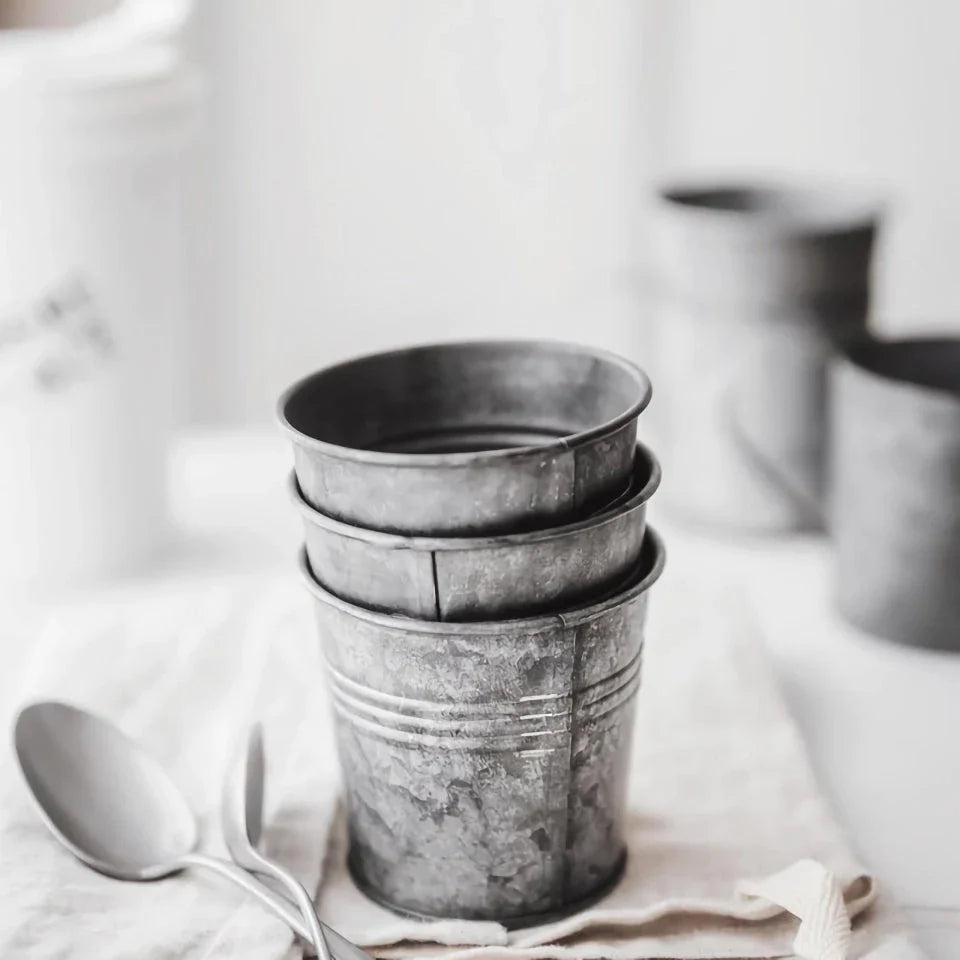 Vintage-inspired metal beverage cup with a charming wrought iron handle, perfect for serving desserts, fruits, and snacks