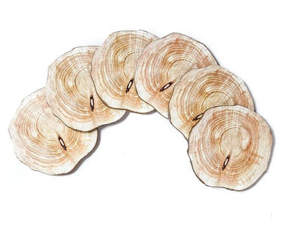 Set of 6 natural timber coasters in various grain patterns, protecting a mug on a wooden surface