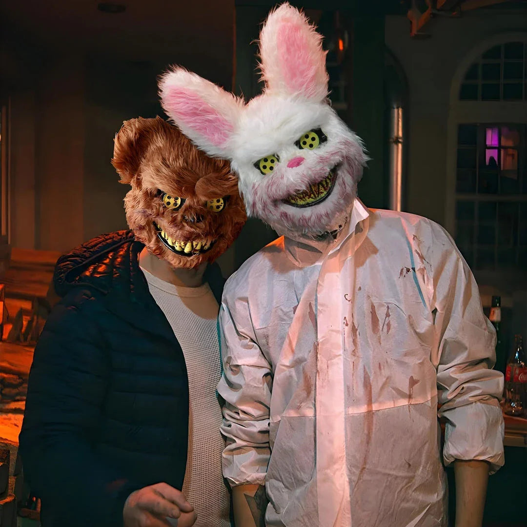 A creepy and realistic plush bunny mask with long pink ears, a bloody mouth, and glowing green eyes - perfect for Halloween and costume parties.