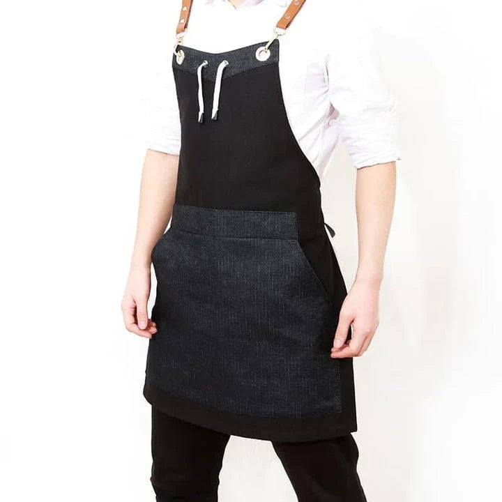 Black canvas barista apron with multiple pockets and adjustable straps, perfect for Kiwi café workers