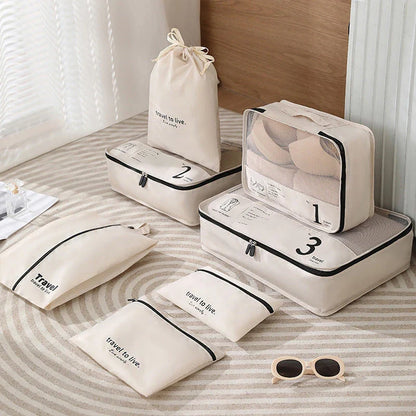 Seven-piece travel organiser set in black with various sized bags for efficient packing and suitcase organisation