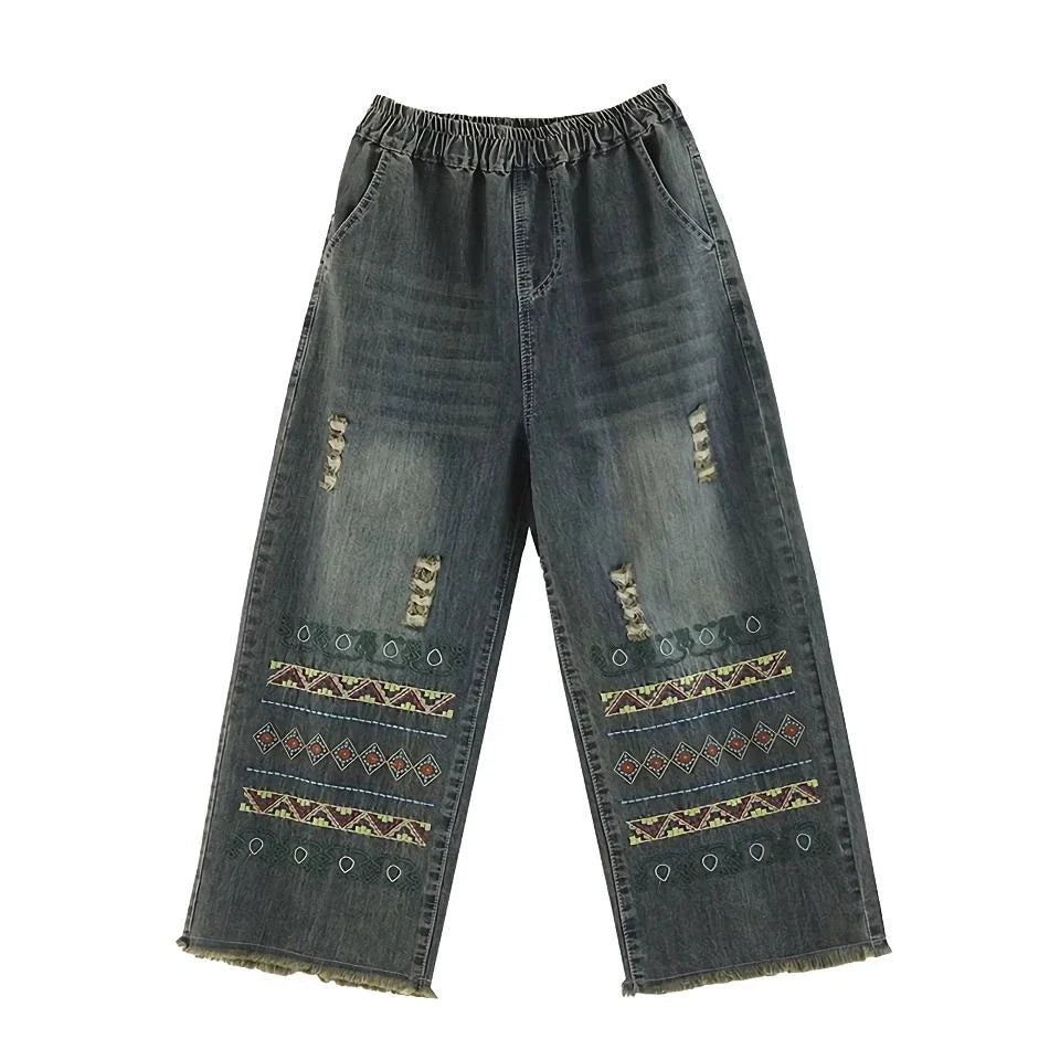 Vintage-inspired embroidered wide-leg jeans in a relaxed, bohemian style with a high-waist design and elastic closure for a personalized fit