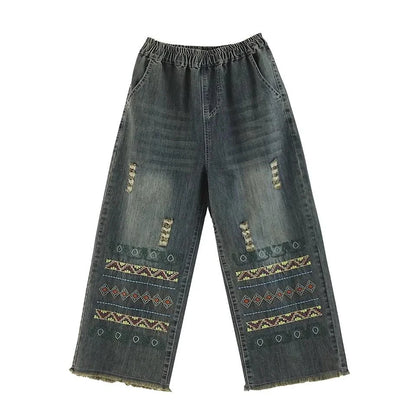 Vintage-inspired embroidered wide-leg jeans in a relaxed, bohemian style with a high-waist design and elastic closure for a personalized fit