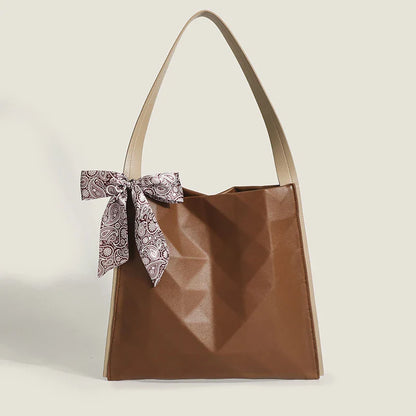 Stylish large-capacity tote bag with a geometric design, made from durable PU leather and featuring a spacious interior and convenient magnetic closure.