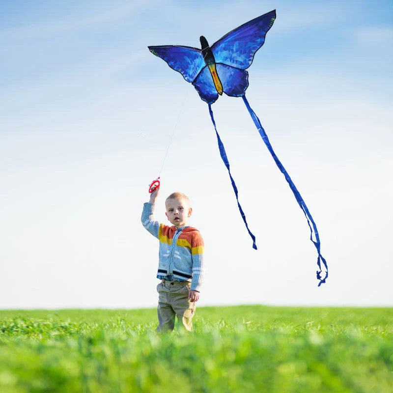 Vibrant red and blue butterfly kite soaring through the skies over New Zealand's scenic landscapes