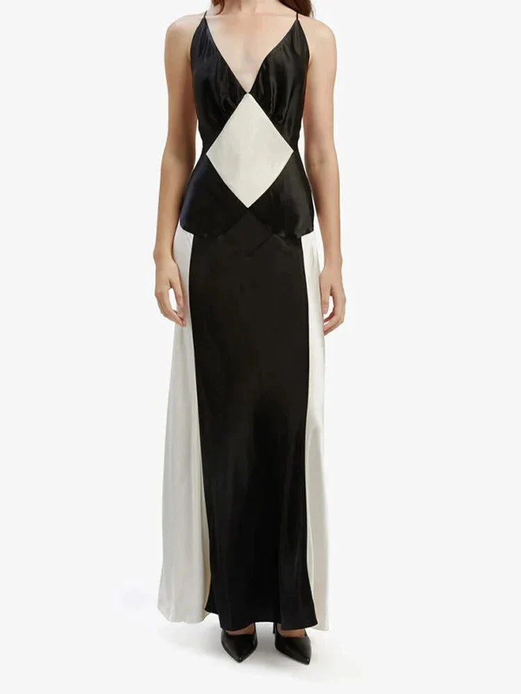 A sleeveless, long sling dress with a geometric black and white pattern, featuring an A-line silhouette and high-waist design.