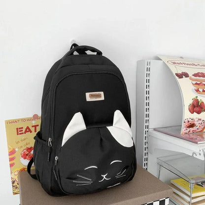 A stylish Japanese-inspired cat backpack with a large capacity, breathable nylon construction, and dedicated storage compartments for student essentials.