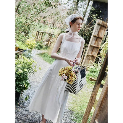 A French-inspired white suspender long dress made of 100% premium cotton for effortless elegance and all-day comfort.