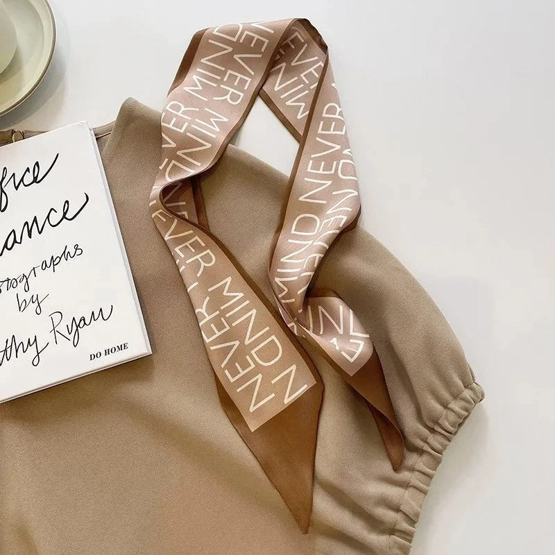 A high-quality silk scarf hair band in a versatile khaki nude color, perfect for adding elegance to any Kiwi outfit.