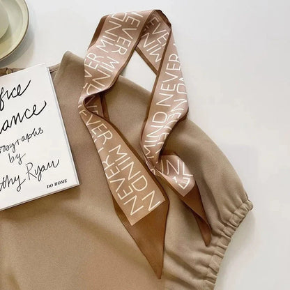 A high-quality silk scarf hair band in a versatile khaki nude color, perfect for adding elegance to any Kiwi outfit.