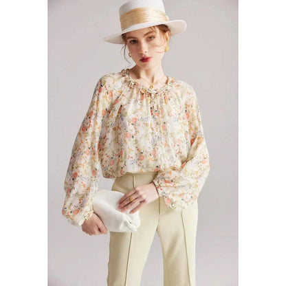 Elegant floral silk-blend blouse with ruffled details and relaxed raglan sleeves