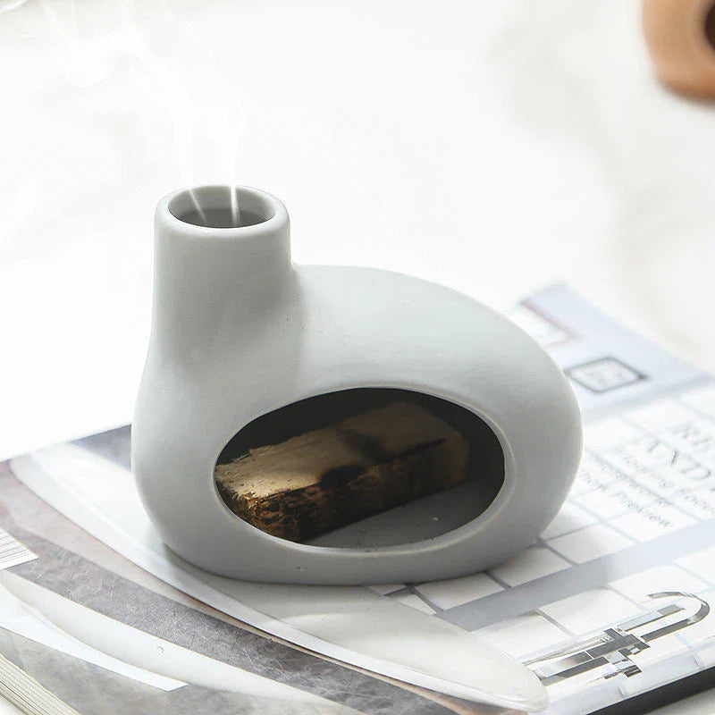 Elegant ceramic Palo Santo incense burner with modern, minimalist design in light brown, white, and gray color options