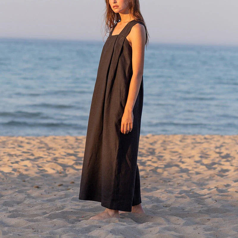 Stylish square collar sleeveless midi sundress in black, featuring a flowing A-line silhouette and practical pockets for versatile summer wear.