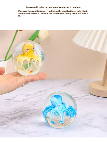 Handcrafted glass octopus windshield washer fluid ornament in ocean blue and tea brown colours, made in New Zealand