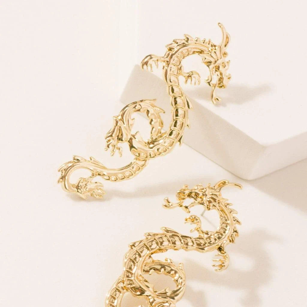 Captivating dragon-shaped stud earrings in gold, a unique New Zealand accessory that adds modern flair to any outfit.