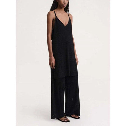 High-waist hollow-out knit trousers in a black color, featuring a straight, wide-leg cut and a sophisticated pattern