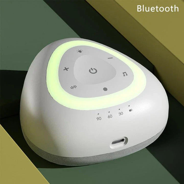 A grey and black white noise machine with ambient lighting, designed to soothe infants and children to sleep