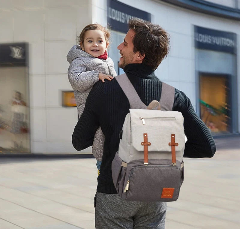 Versatile Mummy Daddy Backpack in Grey, a functional and stylish nappy bag for Kiwi families with a spacious main compartment, insulated pockets, and a USB charging port.