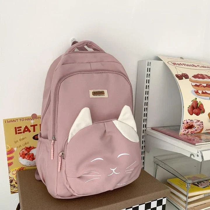 A stylish Japanese-inspired cat backpack with a large capacity, breathable nylon construction, and dedicated storage compartments for student essentials.