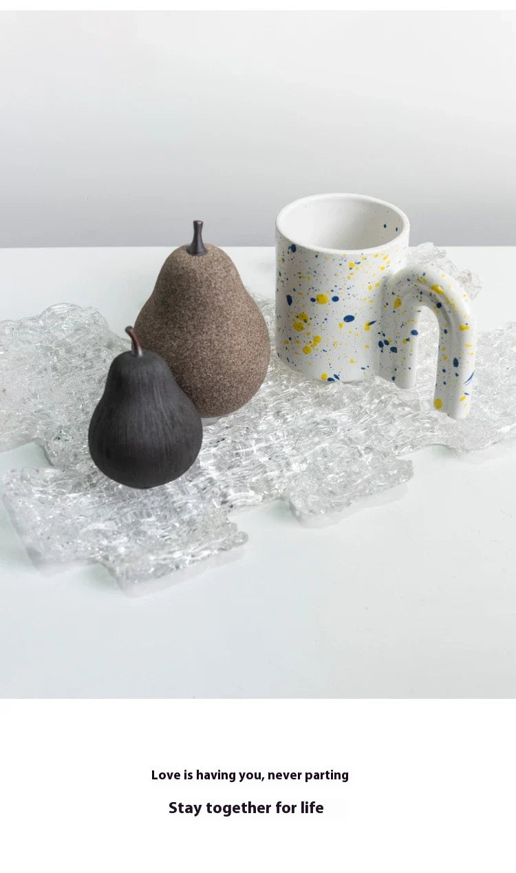 Handcrafted ceramic pear decoration with a sleek, modern design, perfect for adding a touch of natural elegance to any Kiwi home