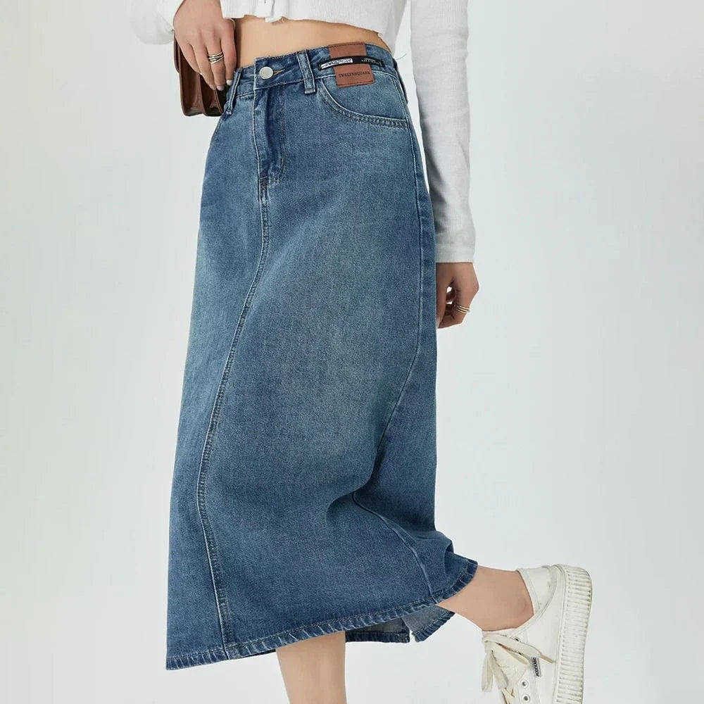 A stylish blue A-line midi denim skirt with a flattering empire waistline, perfect for the modern Kiwi woman's wardrobe