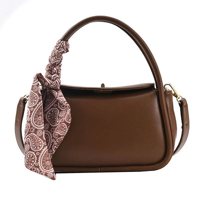 Premium silk scarf handbag in a variety of Kiwi-approved colours, featuring a magnetic buckle closure and oval shape for ample storage.