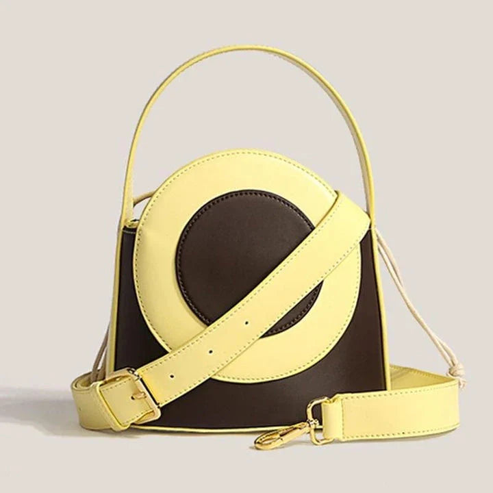 Stylish Kiwi vegan leather bucket bag with a unique colour block design, featuring adjustable straps and interior pockets