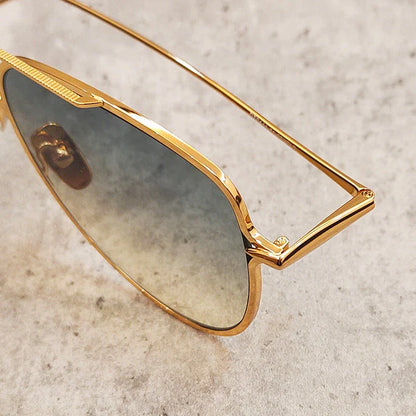 Premium pure titanium pilot sunglasses with a luxurious gold finish, offering superior UV protection and timeless vintage-inspired design.