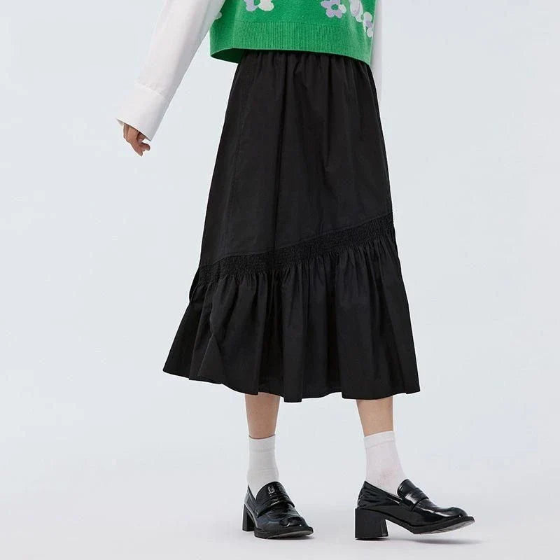 Elegant mid-calf black skirt for women featuring a flattering A-line silhouette and unique irregular hem design