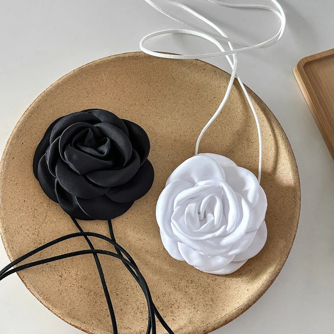 Elegant choker necklace with a large, geometric rose flower pendant in black and white colors