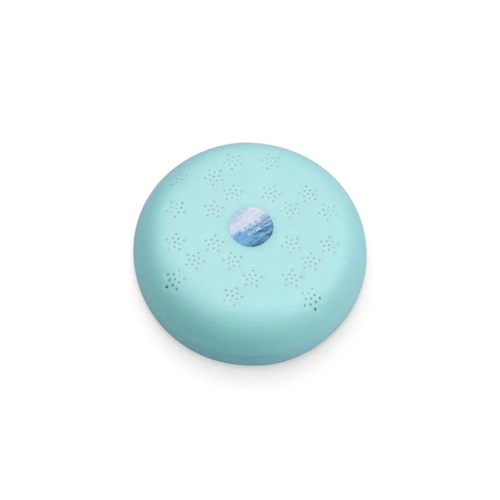 Macaron-shaped car air freshener with floral-shaped fragrance outlets and a sticker base for easy dashboard attachment