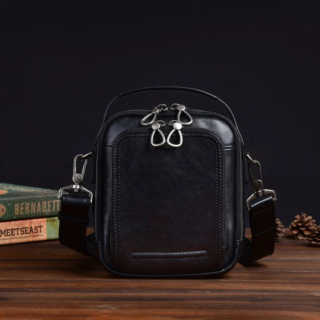 A rugged, retro-inspired cowhide messenger bag made in New Zealand, featuring a spacious interior, multiple pockets, and a comfortable single strap design.