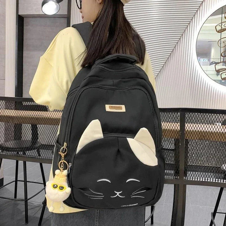 A stylish Japanese-inspired cat backpack with a large capacity, breathable nylon construction, and dedicated storage compartments for student essentials.