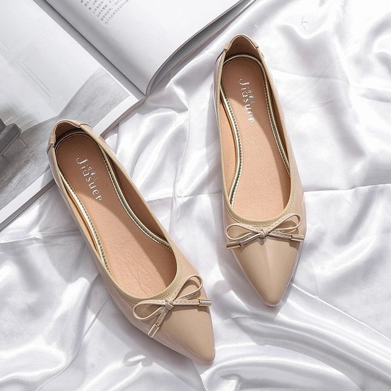 Stylish black pointed toe flats with bow knot and beading detail, perfect for Kiwi fashion