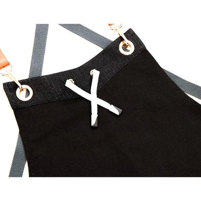 Black canvas barista apron with multiple pockets and adjustable straps, perfect for Kiwi café workers