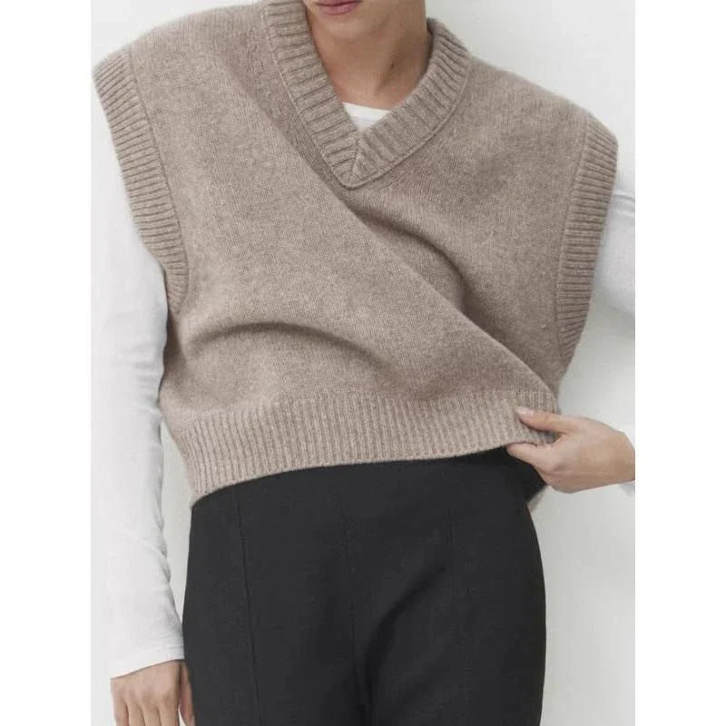 A cosy and stylish women's knitted vest in a neutral colour, with a V-neck design and sleeveless silhouette for easy layering.