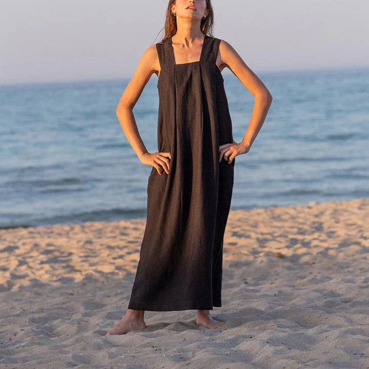 Stylish square collar sleeveless midi sundress in black, featuring a flowing A-line silhouette and practical pockets for versatile summer wear.