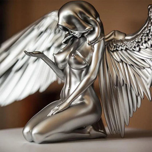 A silver resin ornament featuring the graceful silhouette of angel wings, perfect for adding a touch of Kiwi charm to your home decor.