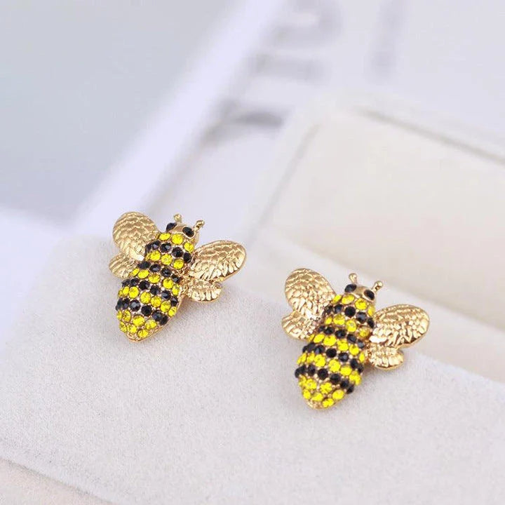 Elegant three-dimensional diamond bee stud earrings in a gold tone, featuring a sparkling design that adds a touch of whimsy and sophistication.