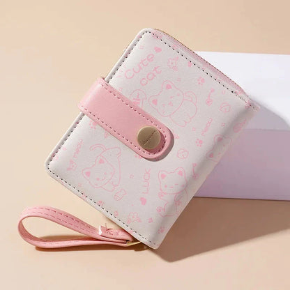 A stylish compact wallet featuring a playful cat-themed design with a tilted head motif, available in a range of candy-inspired colours.