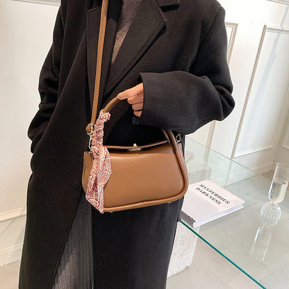 Premium silk scarf handbag in a variety of Kiwi-approved colours, featuring a magnetic buckle closure and oval shape for ample storage.