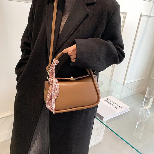 Premium silk scarf handbag in a variety of Kiwi-approved colours, featuring a magnetic buckle closure and oval shape for ample storage.