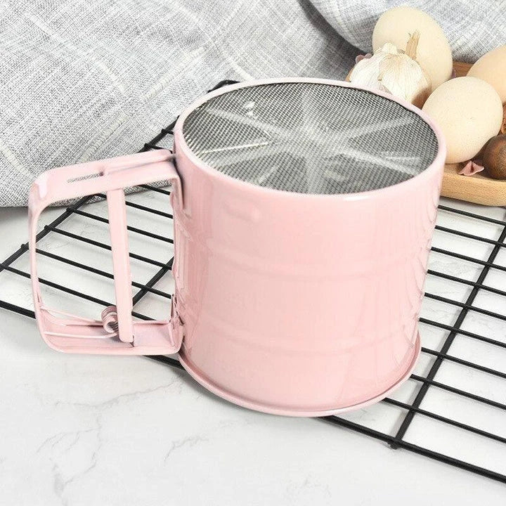 Elegant macaron pink handheld flour sifter with stainless steel construction, perfect for Kiwi bakers