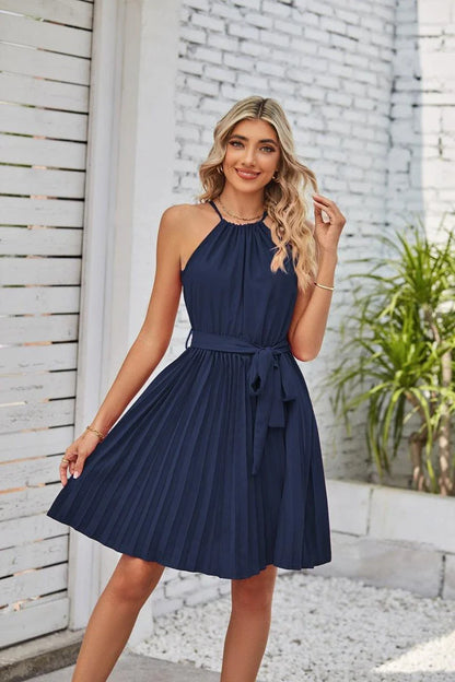 A stylish halter sundress with a pleated skirt, perfect for warm Kiwi summer days